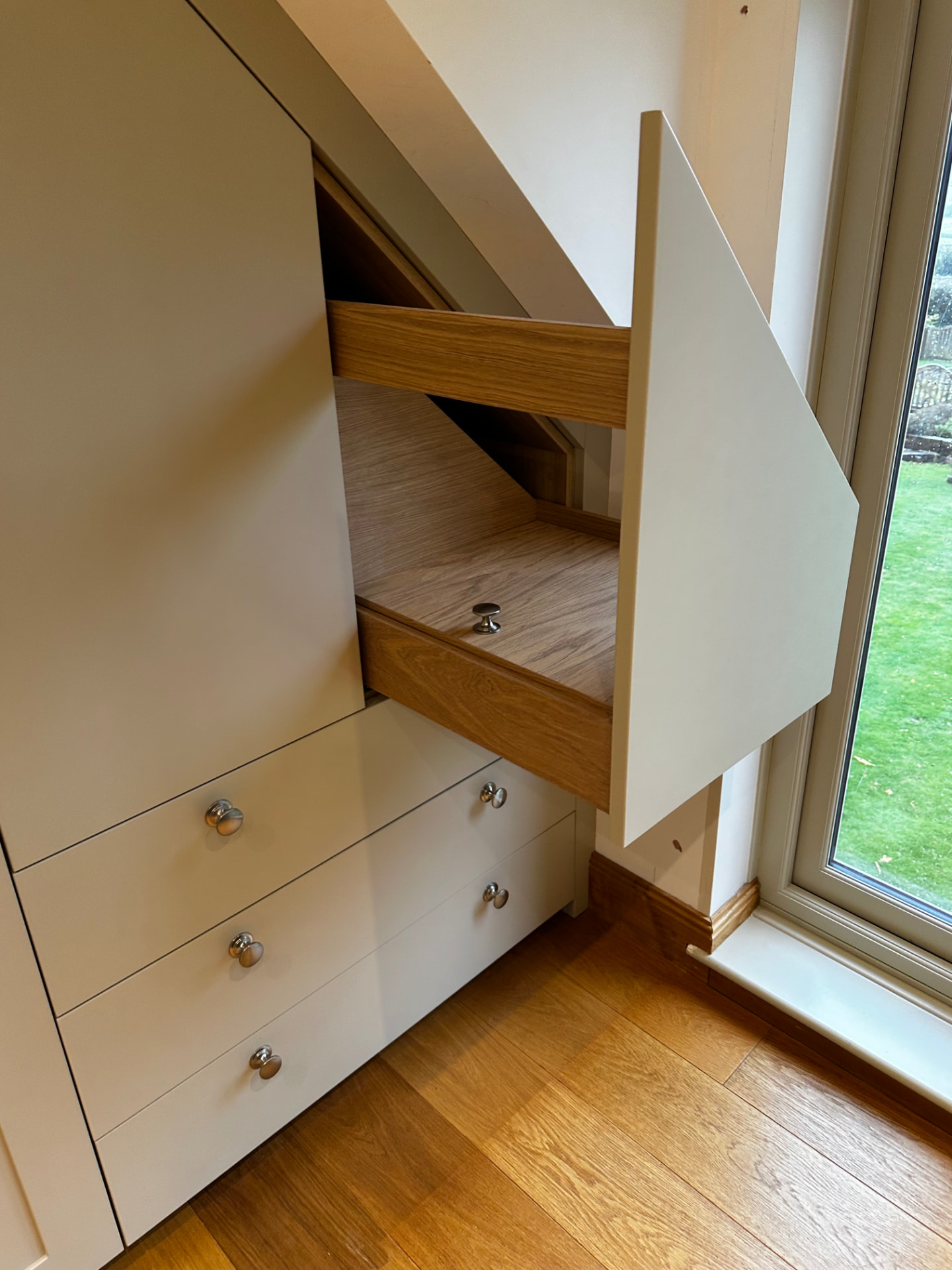 Made-to-measure wardrobe storage with a pull-out oak-lined drawer