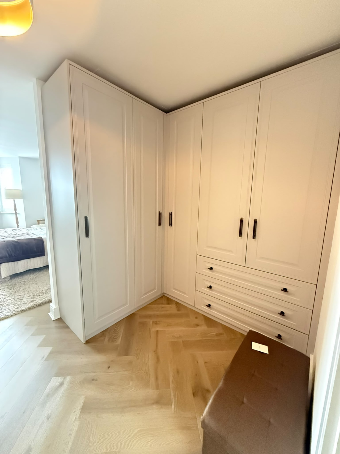 White shaker corner wardrobes with integrated drawers